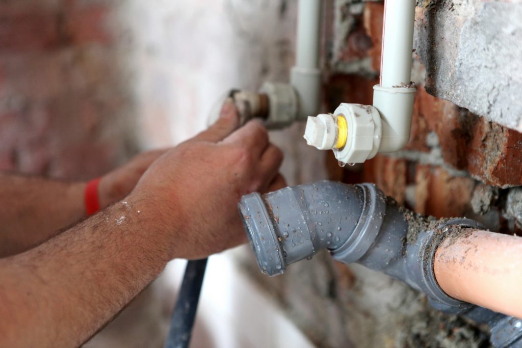 worker's hands of pipes